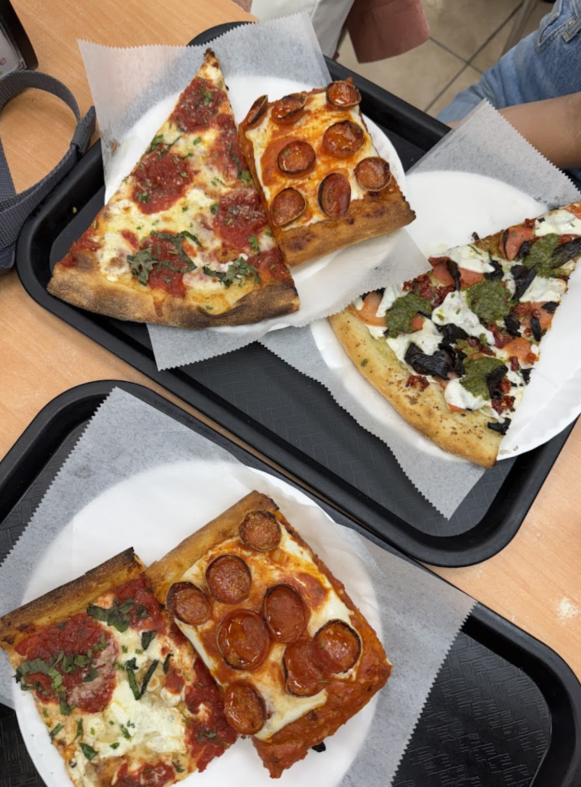 An assortment of New York pizza slices and squares from Little Italy Pizza on 45th