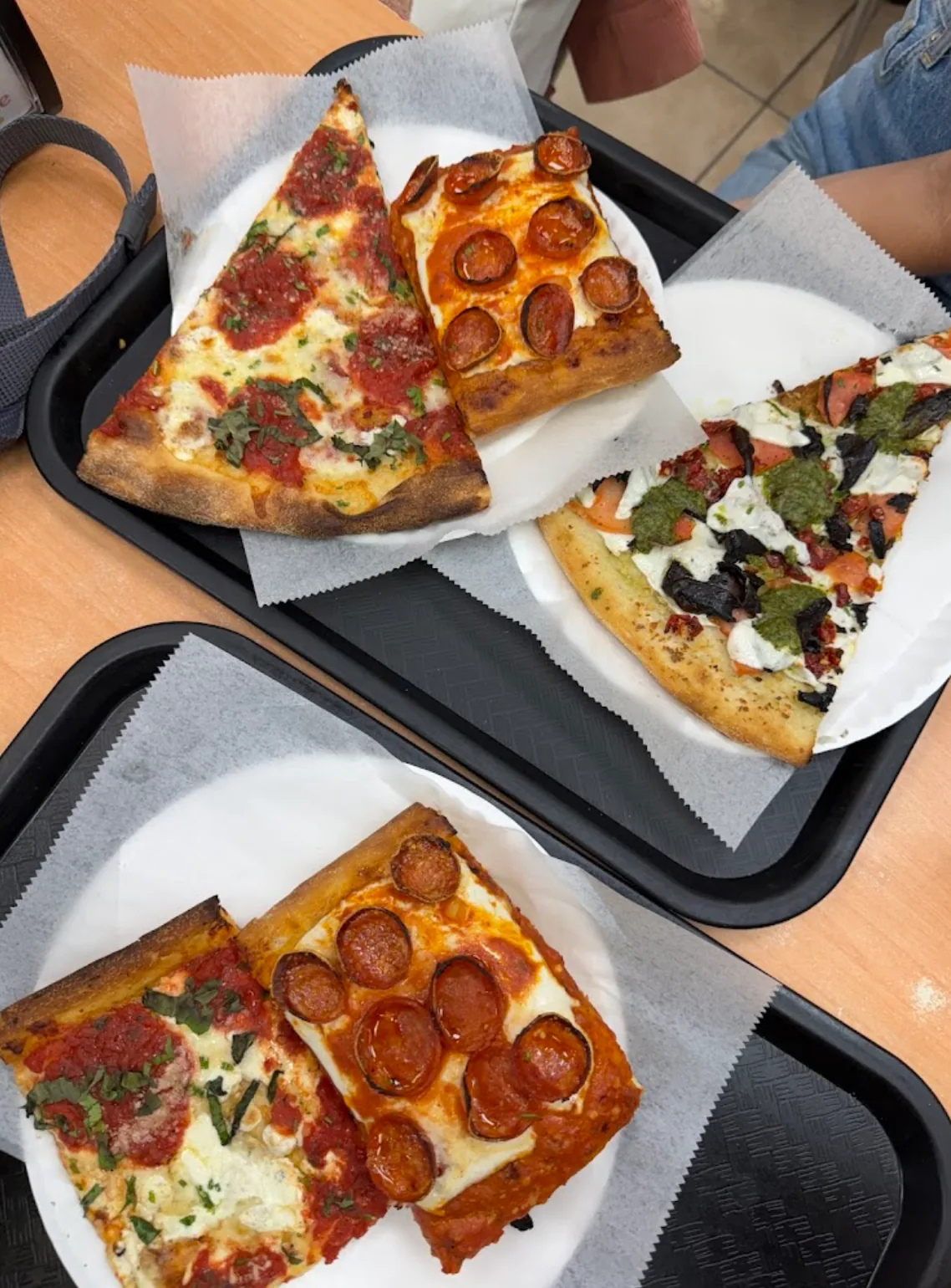 An assortment of New York pizza slices and squares from Little Italy Pizza on 45th