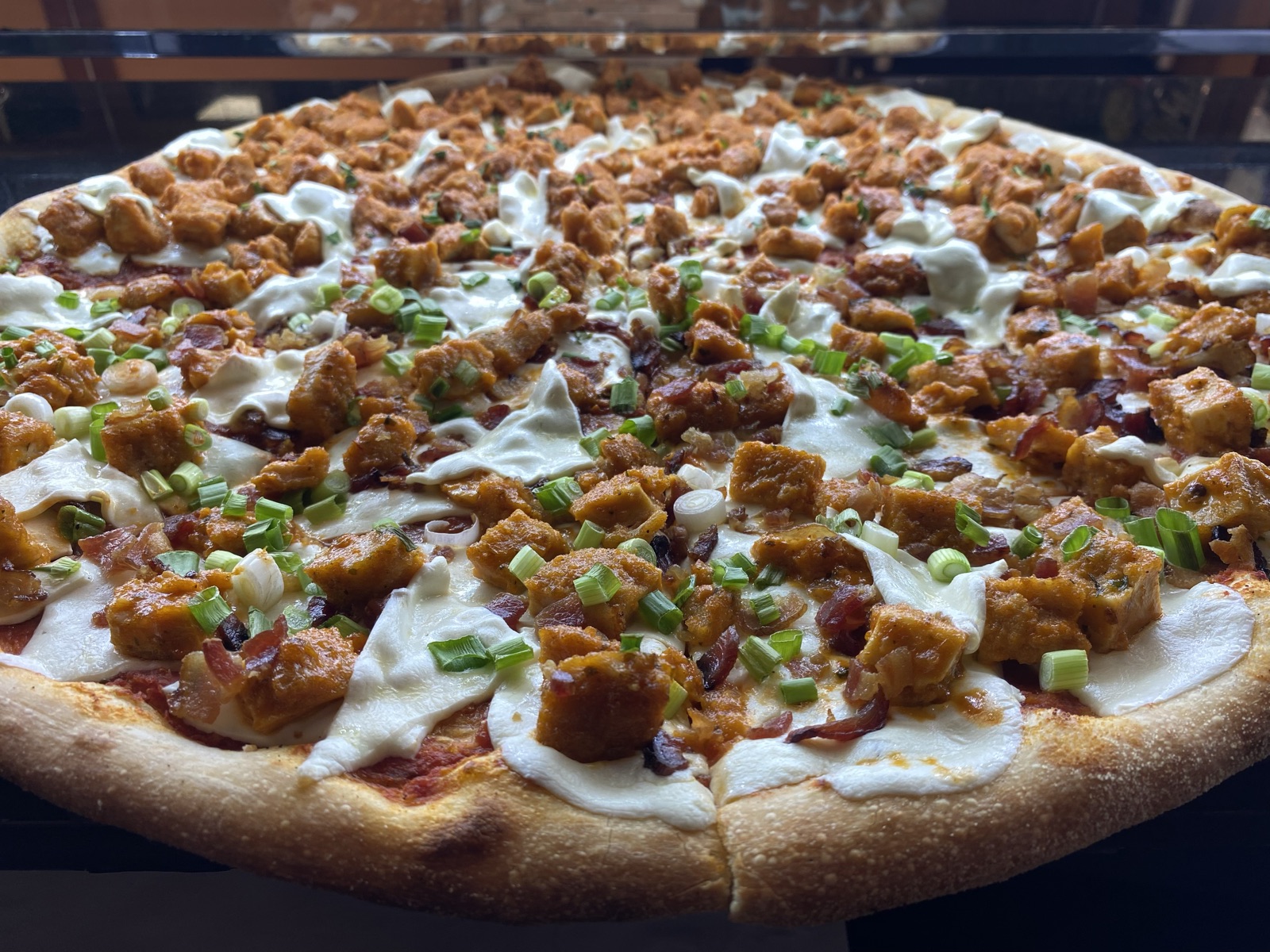 Chipotle chicken pizza with fresh mozzarella, bacon, and scallions